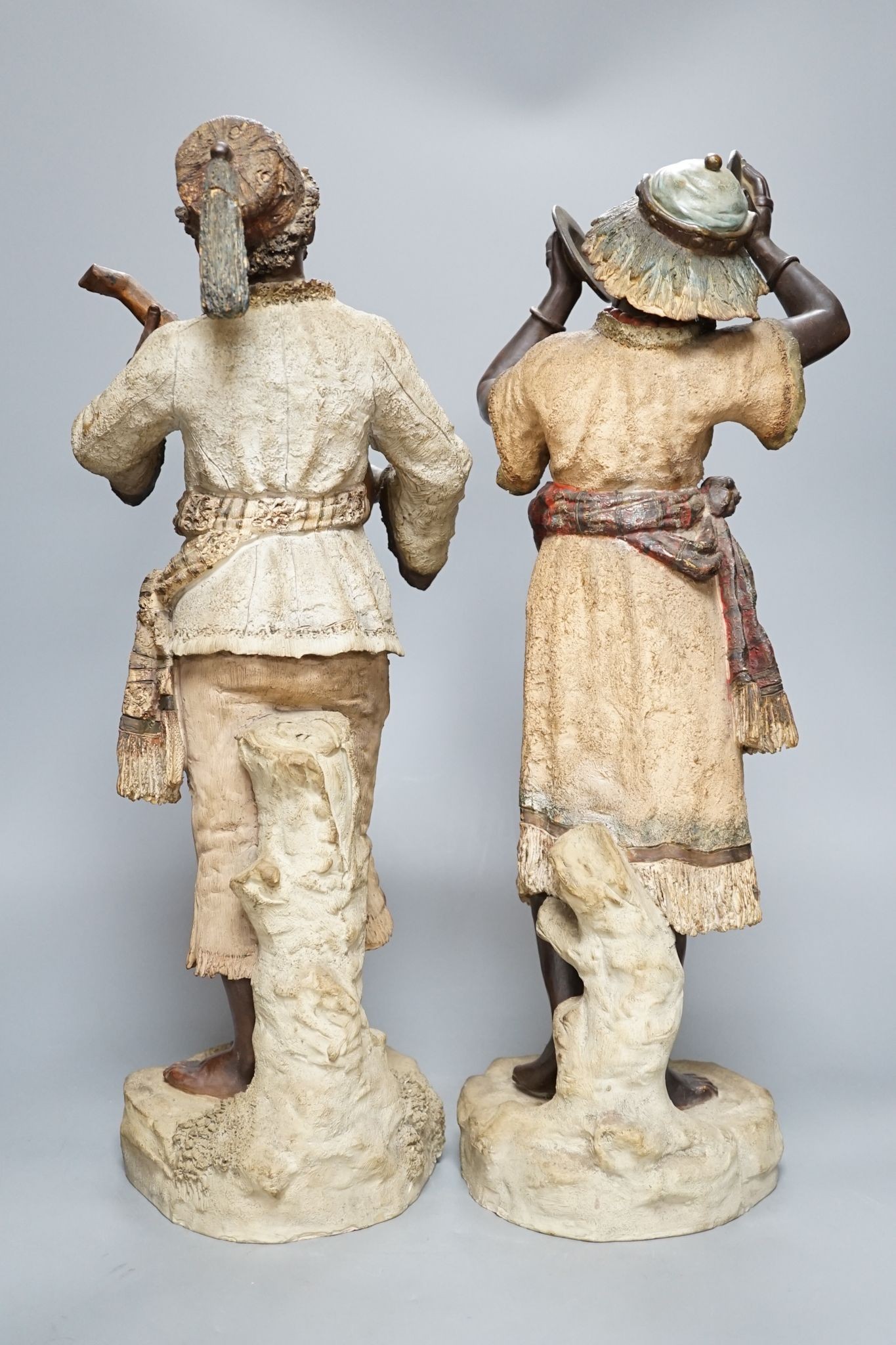 A pair of terracotta musician figures, incised numbers to base, 49cm